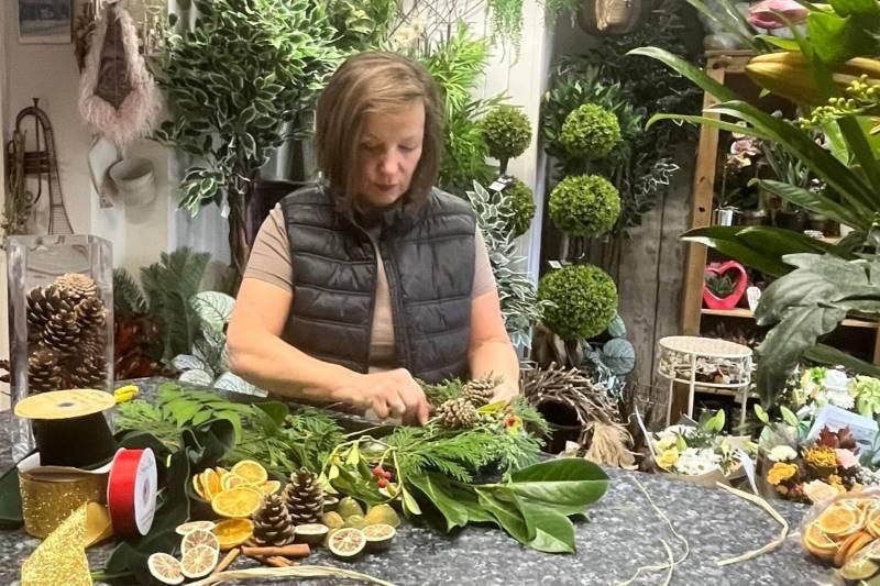 Image of a lady creating a Christmas wreath