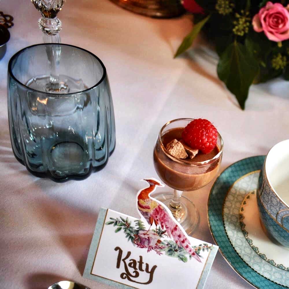 Dining table set for dinner with a place card with the name Katy