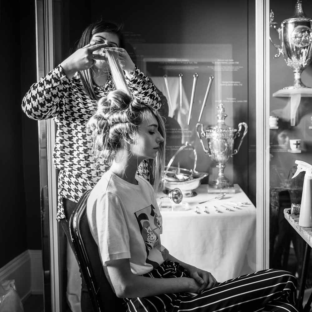 A lady having her hair styled in preparation for an event at the Mansion House.