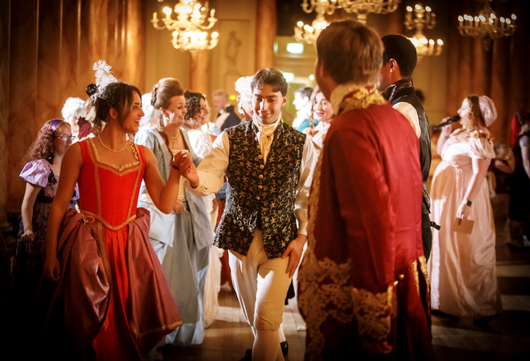 A man and a woman in Georgian costumes dance