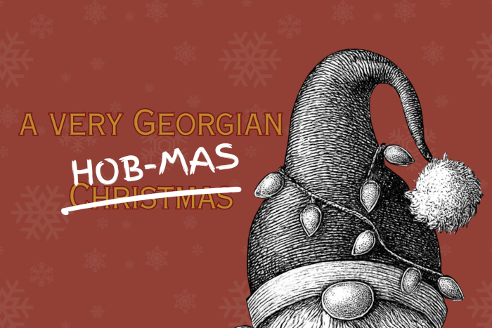 Text reading 'A Very Georgian Hob-Mas' to the left of a Santa hat with festive lights on top